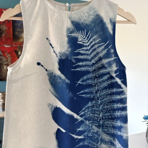 Woman, sleeveless top, cyanotype of a fern
